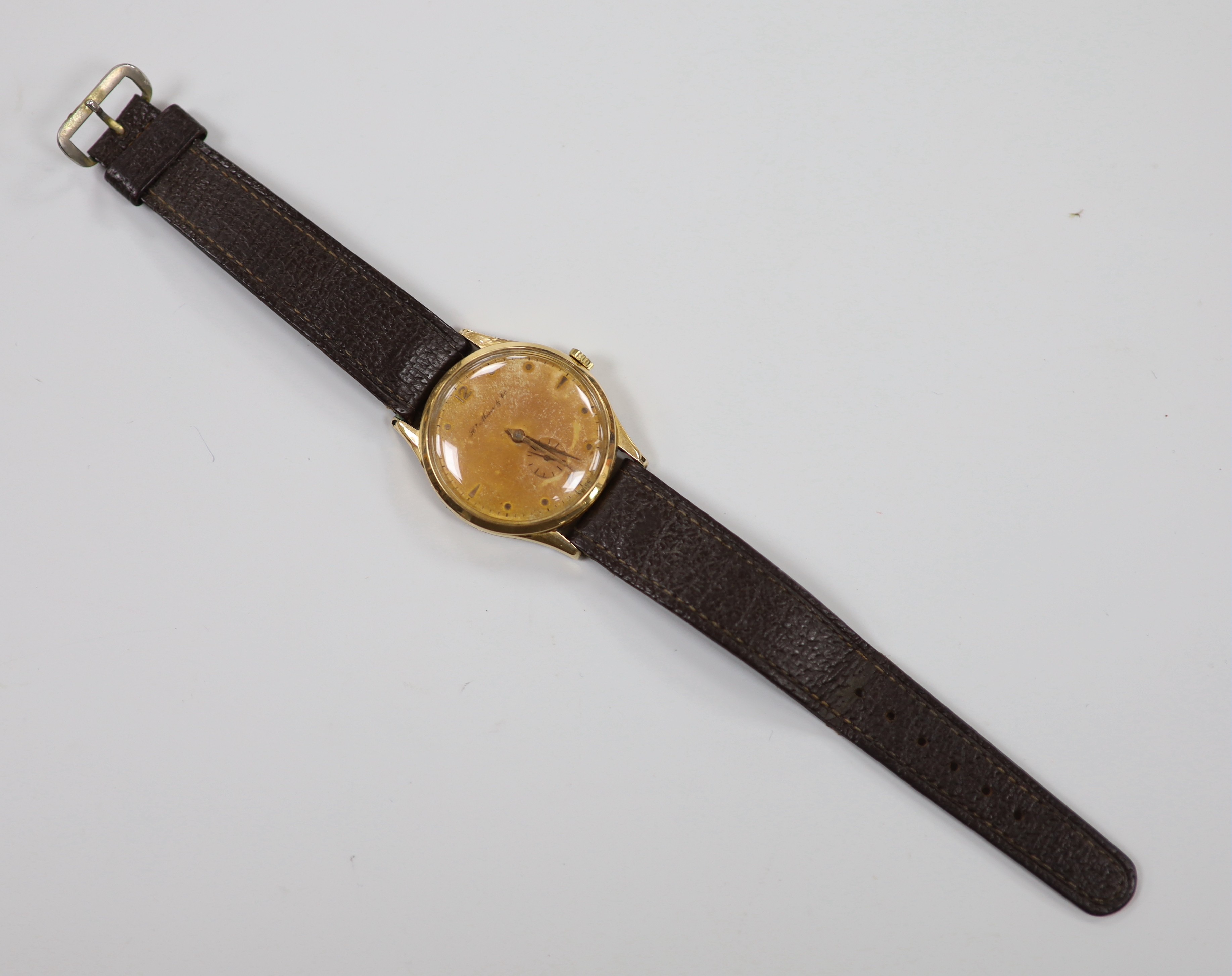 A gentleman's 1950's? 18k manual wind wrist watch, retailed by H. Moser & Cie, with subsidiary seconds, case diameter 36mm, on leather strap, gross weight 37.7 grams.